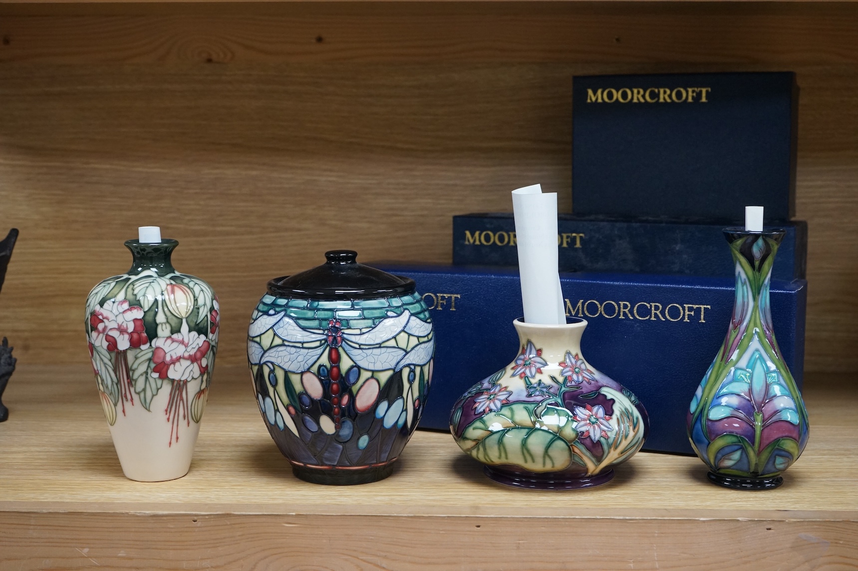 Four Moorcroft vases: Favrile Jar, Kerry vase, Cleopatra vase and a Borage vase. All boxed, tallest 17cm